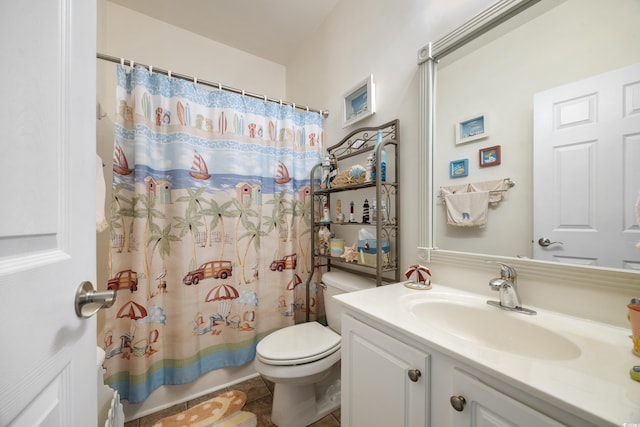 bathroom featuring tile patterned flooring, vanity, and toilet