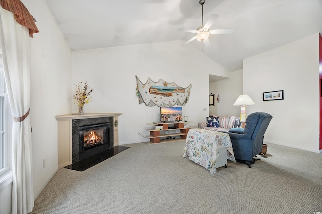 living room with ceiling fan, vaulted ceiling, and carpet floors