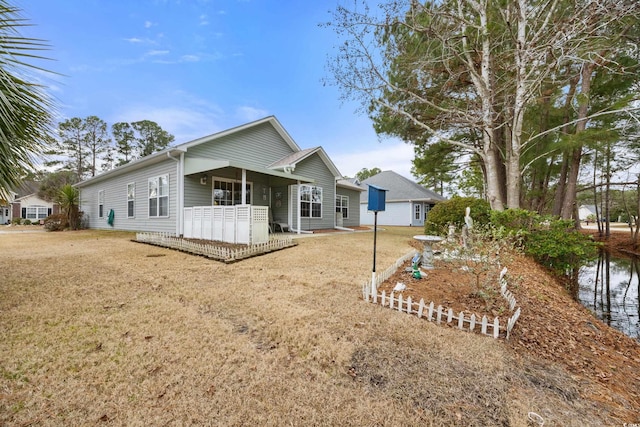 rear view of house featuring a lawn