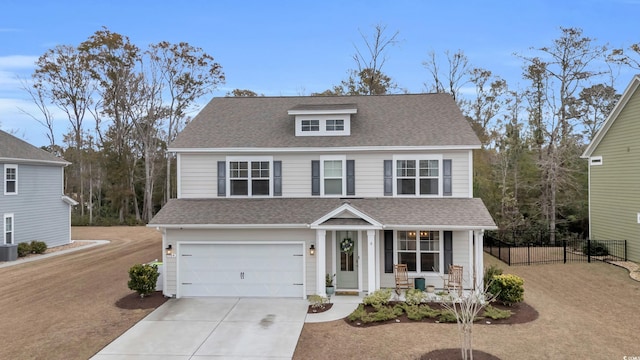 traditional-style house with a porch, a garage, cooling unit, concrete driveway, and fence