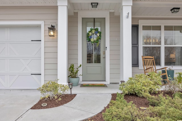 property entrance with covered porch and a garage