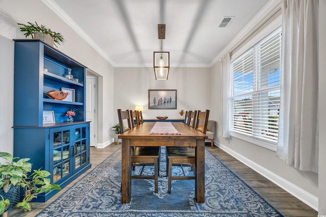 dining room featuring crown molding and dark hardwood / wood-style flooring