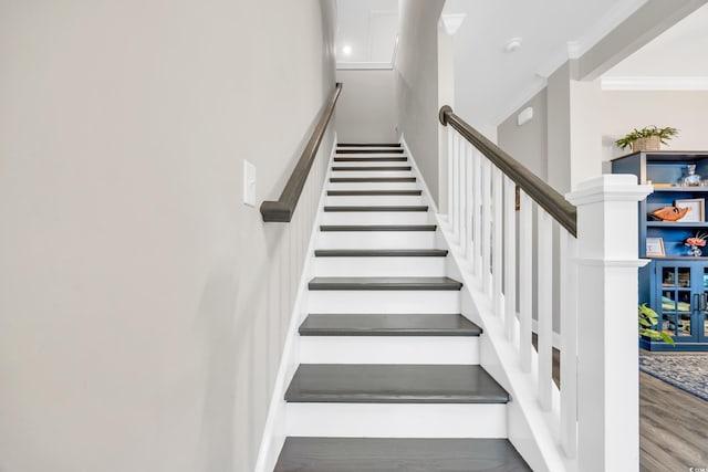 stairway featuring ornamental molding