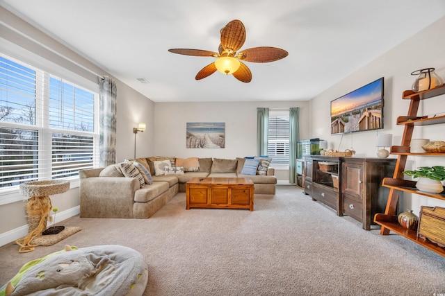 carpeted living room featuring ceiling fan, baseboards, and visible vents