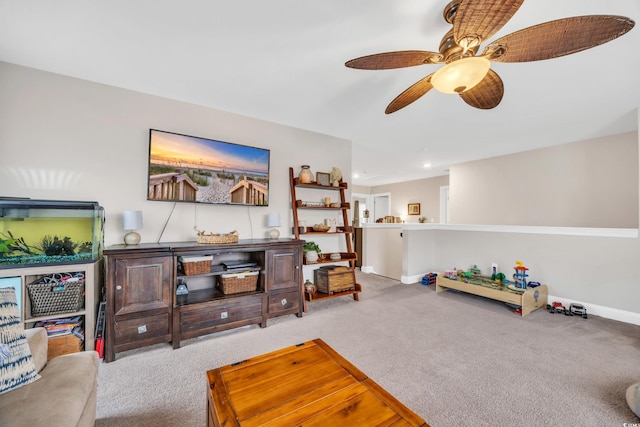 carpeted living room with a ceiling fan and baseboards