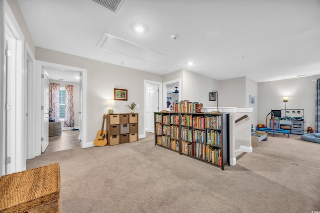 interior space featuring baseboards, visible vents, attic access, and carpet