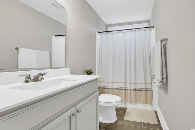 bathroom featuring lofted ceiling, vanity, and toilet