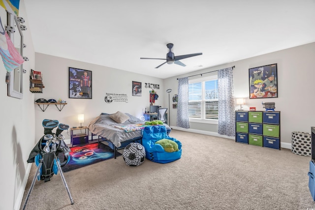 carpeted bedroom with baseboards and ceiling fan