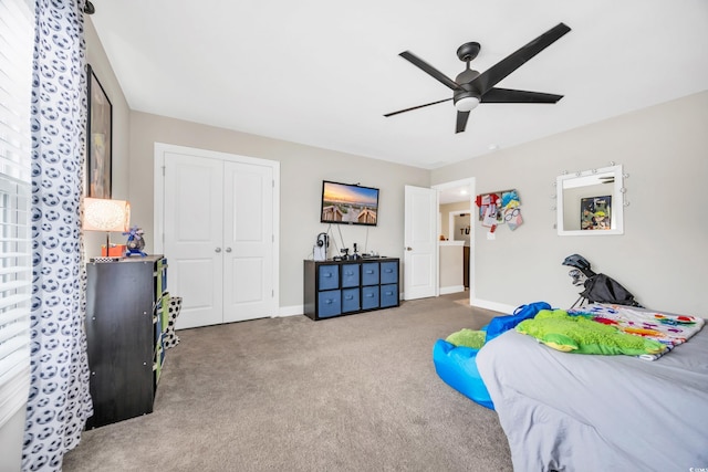 carpeted bedroom with a closet and ceiling fan