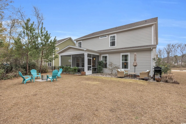 rear view of house featuring a patio area, a fire pit, and a sunroom