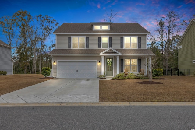 traditional home featuring a lawn, driveway, roof with shingles, an attached garage, and fence