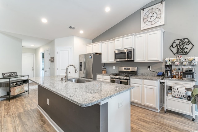 kitchen with white cabinetry, sink, a kitchen island with sink, and stainless steel appliances