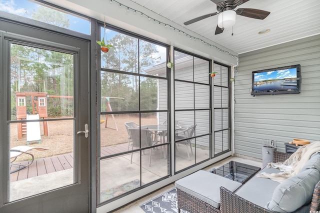 sunroom / solarium featuring plenty of natural light and ceiling fan