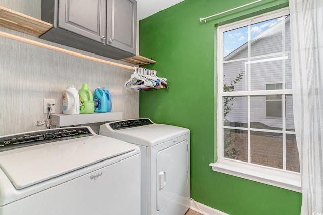 laundry room featuring cabinets and washing machine and clothes dryer