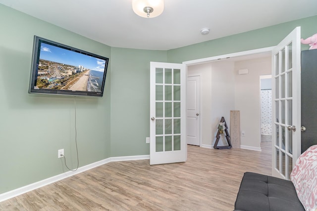 unfurnished room featuring light wood-type flooring and french doors