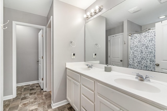 bathroom featuring vanity and a shower with shower curtain