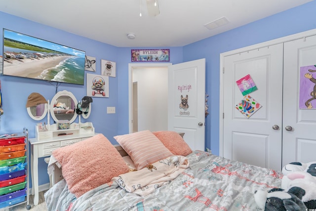 bedroom with ceiling fan and a closet