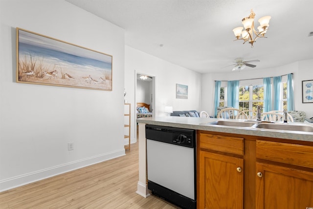 kitchen with ceiling fan with notable chandelier, light hardwood / wood-style floors, dishwasher, and sink