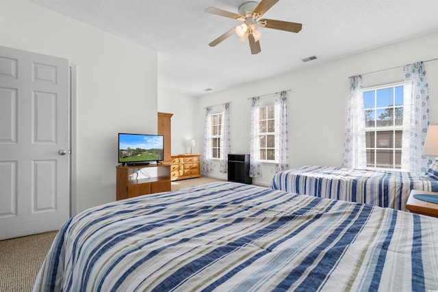 bedroom with ceiling fan and carpet