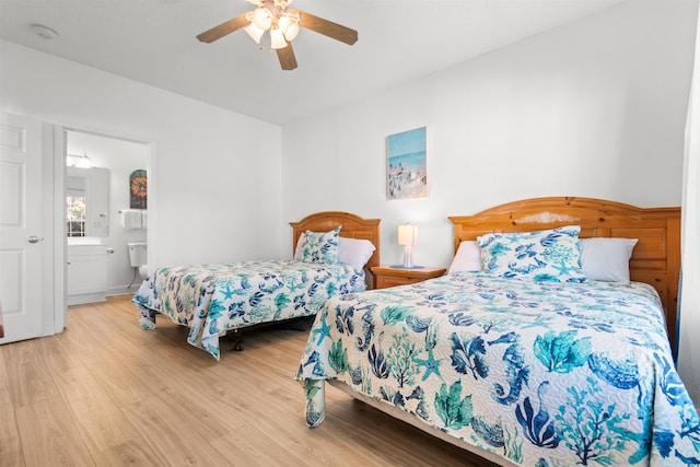 bedroom featuring ceiling fan, light wood-type flooring, and connected bathroom