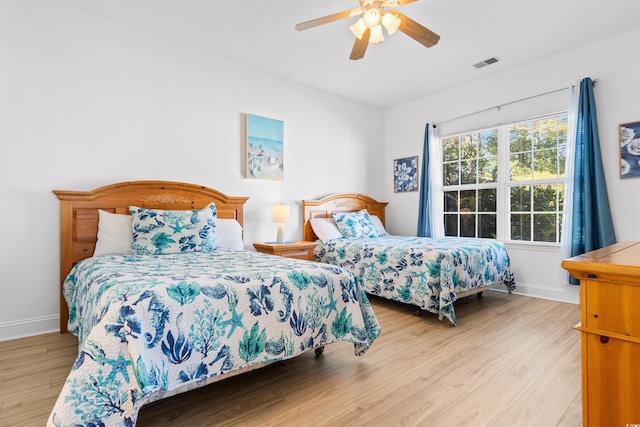 bedroom with ceiling fan and light hardwood / wood-style flooring