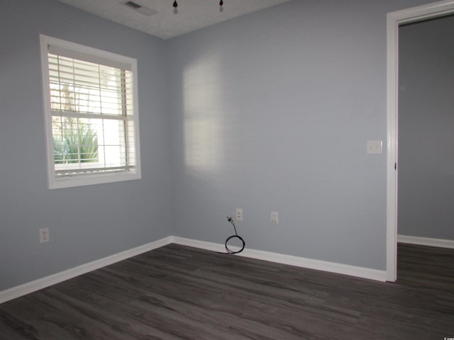 spare room with dark hardwood / wood-style floors