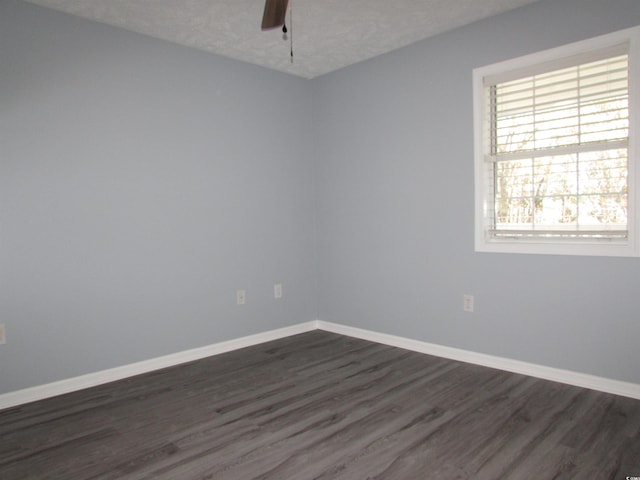 empty room featuring a textured ceiling, dark hardwood / wood-style floors, and ceiling fan