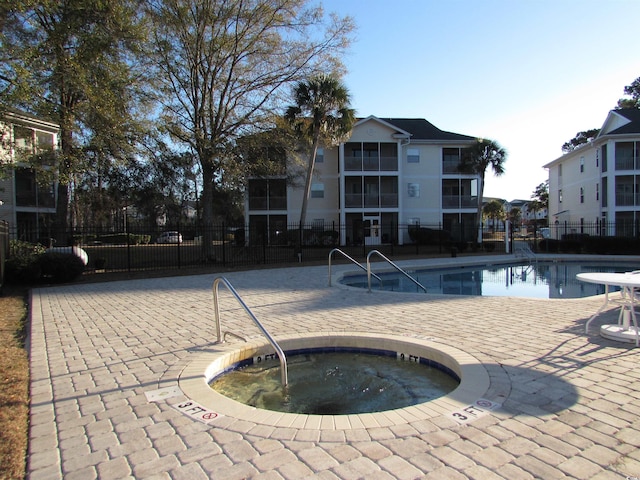 view of pool featuring a community hot tub