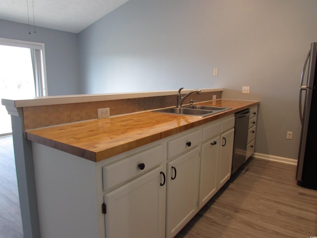 kitchen featuring white cabinetry, sink, kitchen peninsula, and appliances with stainless steel finishes