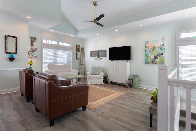 living room with ceiling fan, ornamental molding, lofted ceiling, and hardwood / wood-style floors