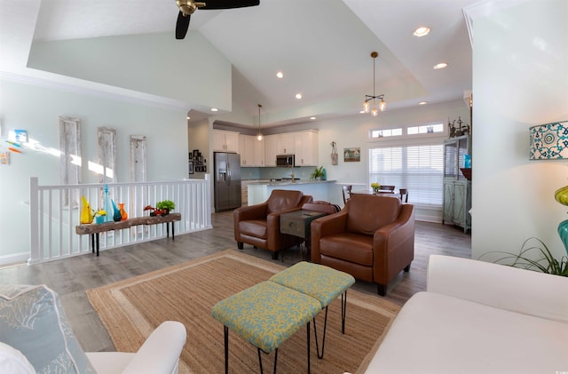 living room featuring ceiling fan, light hardwood / wood-style flooring, and high vaulted ceiling