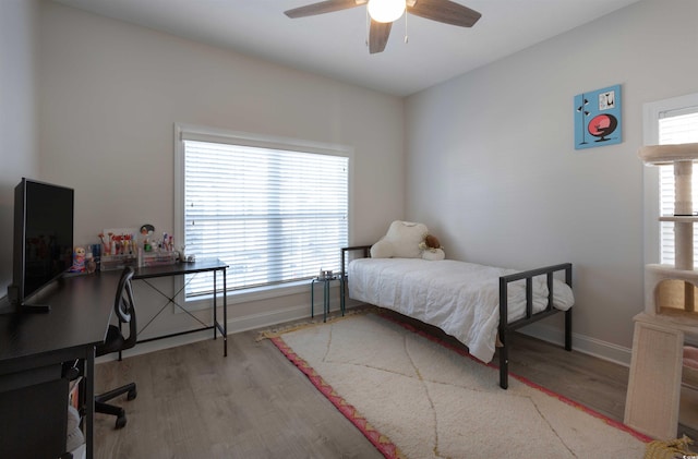 bedroom with ceiling fan and light hardwood / wood-style flooring