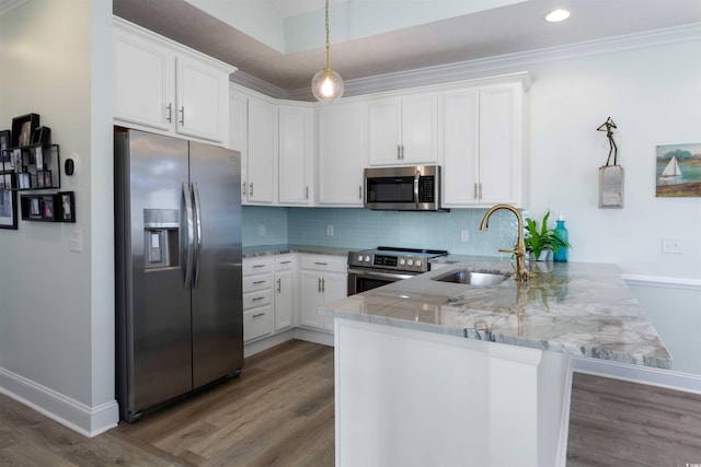 kitchen featuring white cabinetry, kitchen peninsula, appliances with stainless steel finishes, decorative backsplash, and light stone counters