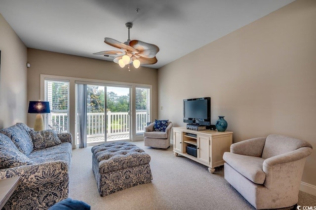 carpeted living room featuring ceiling fan and a wealth of natural light