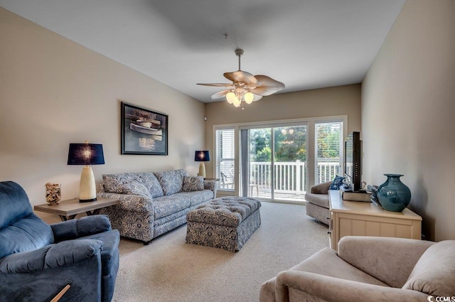 living room with ceiling fan and light colored carpet