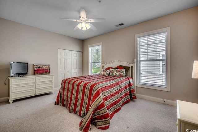 carpeted bedroom with a closet and ceiling fan