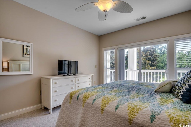 carpeted bedroom featuring multiple windows, access to outside, and ceiling fan