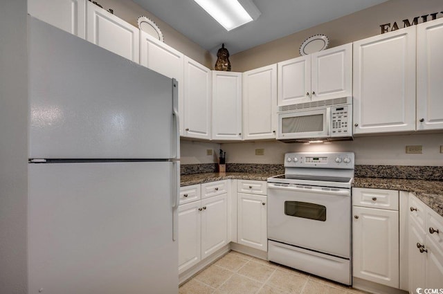 kitchen with white appliances and white cabinets