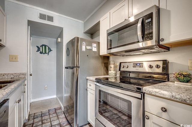 kitchen featuring light stone counters, crown molding, white cabinets, and stainless steel appliances