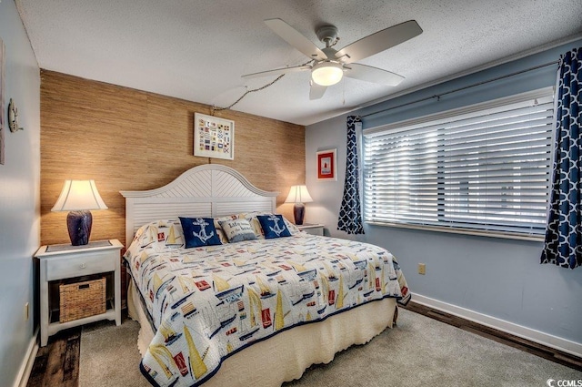 bedroom featuring a textured ceiling, ceiling fan, and wood-type flooring