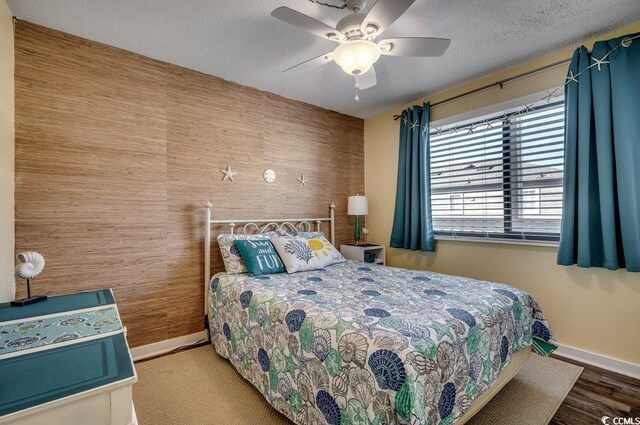 bedroom with ceiling fan and a textured ceiling