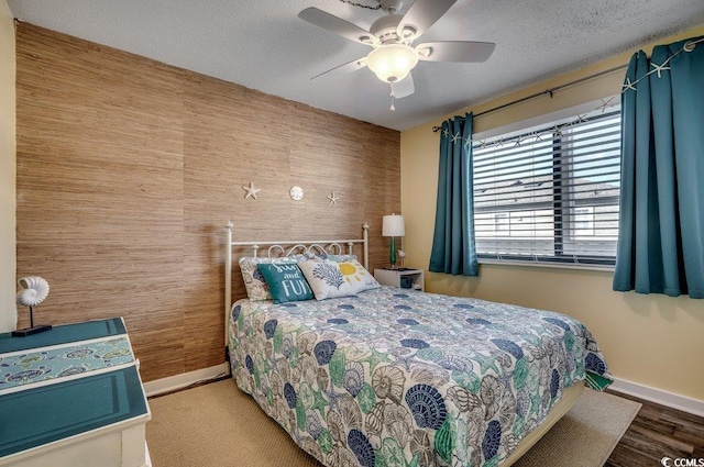 bedroom with a textured ceiling and ceiling fan