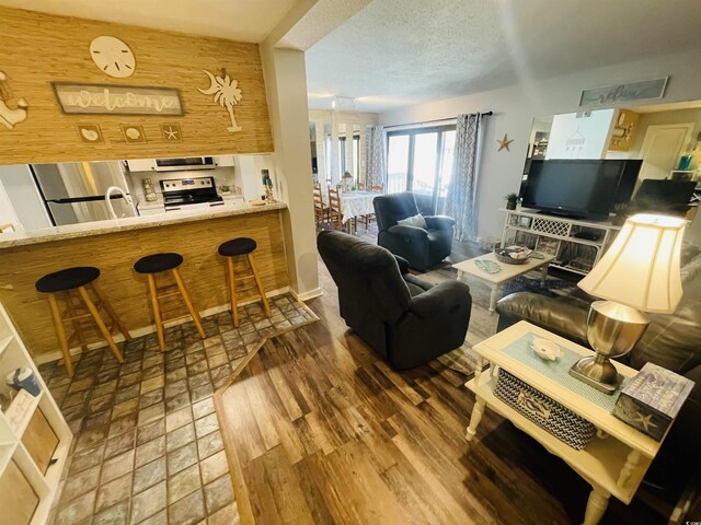 living room featuring a textured ceiling and dark hardwood / wood-style flooring