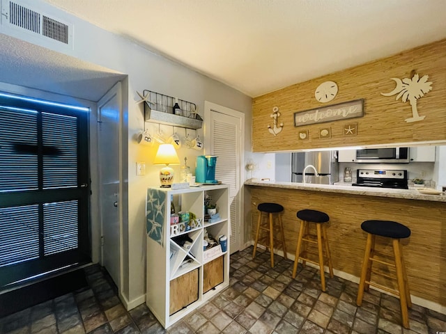 bar with appliances with stainless steel finishes