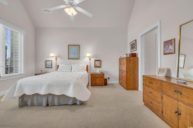 carpeted bedroom with ceiling fan and vaulted ceiling