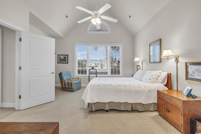 carpeted bedroom with ceiling fan and high vaulted ceiling