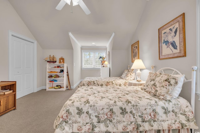 carpeted bedroom featuring a closet, ceiling fan, vaulted ceiling, and crown molding