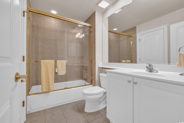 full bathroom with toilet, tile patterned floors, vanity, and bath / shower combo with glass door