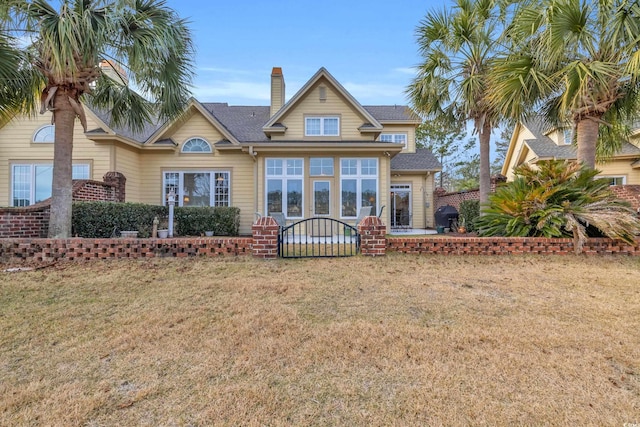 rear view of property with a yard