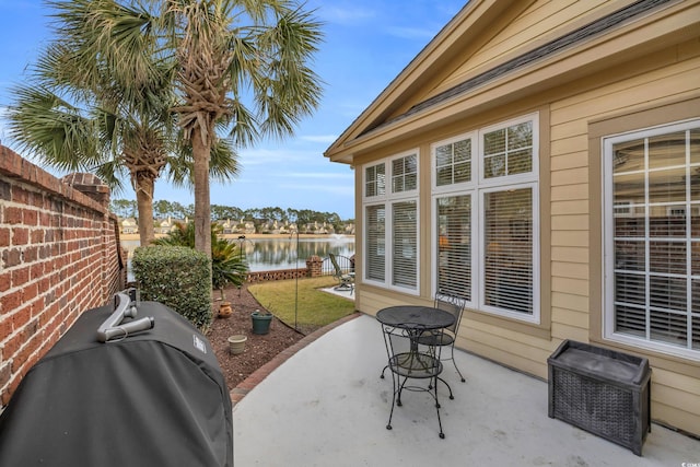 view of patio / terrace featuring a grill and a water view